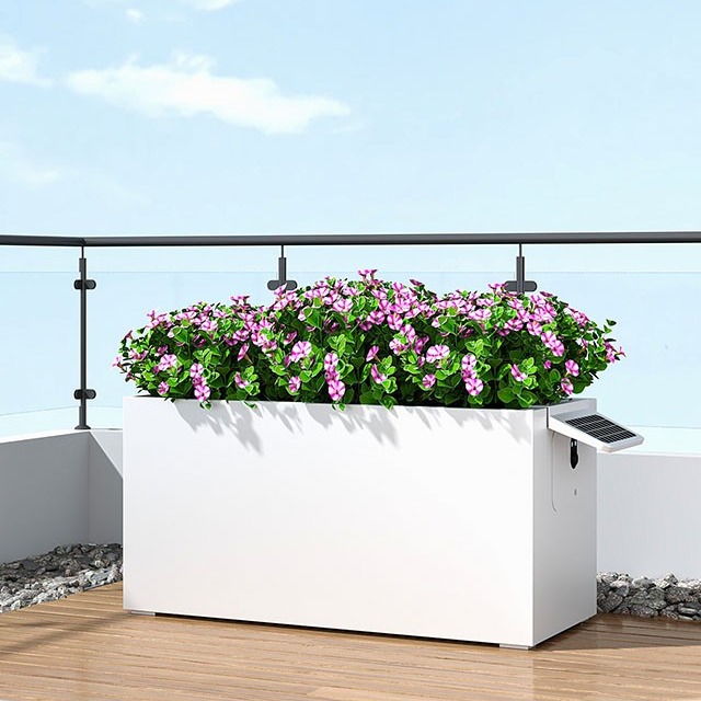 BloomBox S1 smart planter with pink flowers on a balcony